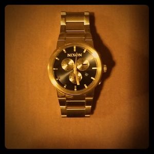 Nixon Gold and black stainless steel watch